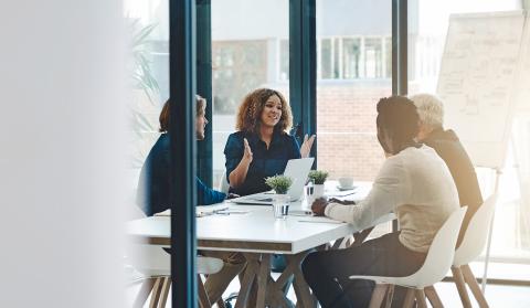 People sat round a table having a meeting image