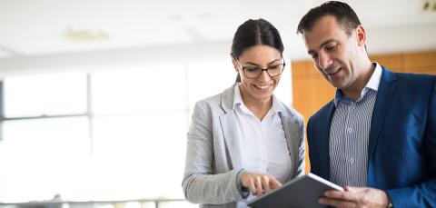 Two people looking at a tablet