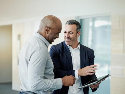 Two people looking at a tablet